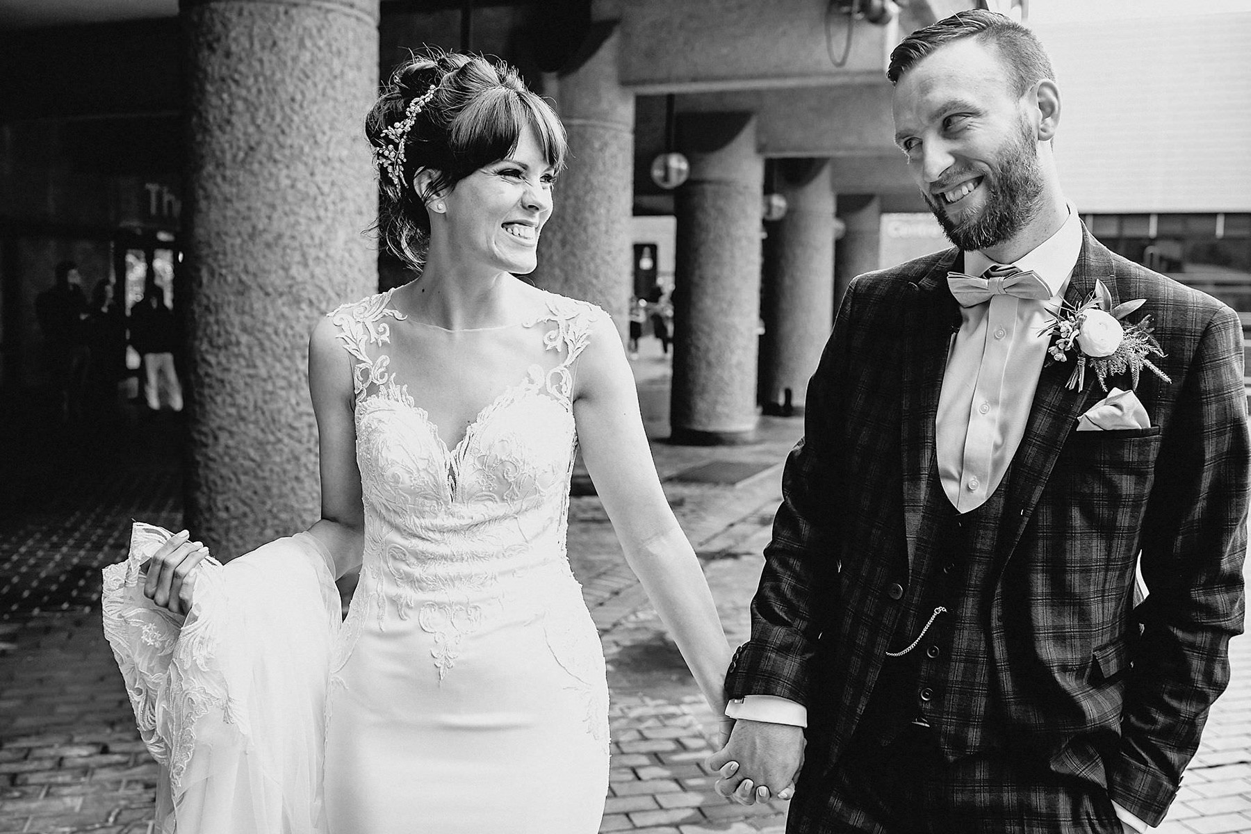 black and white photo, walking, bride and groom 