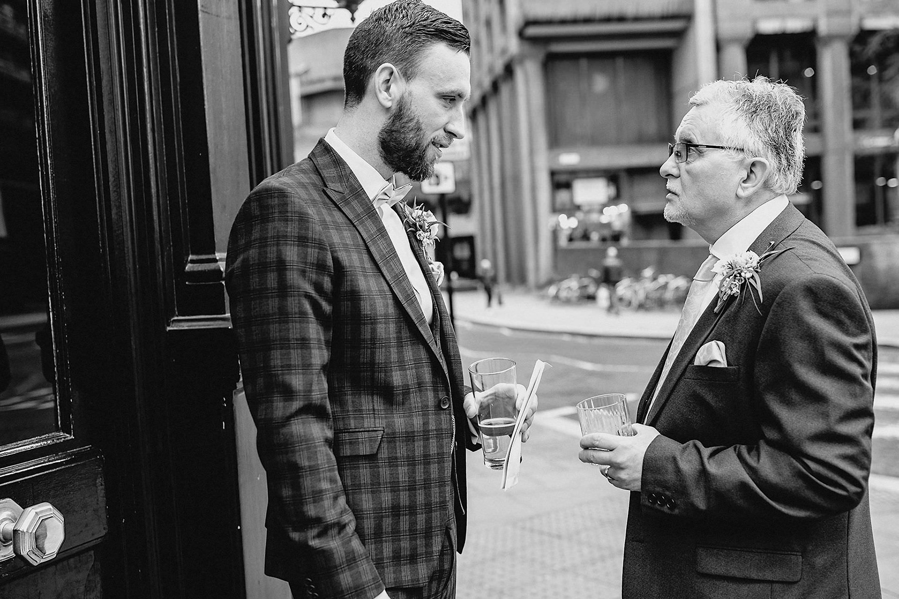 groom with his dad, father of the groom, suits, buttonholes, flowers