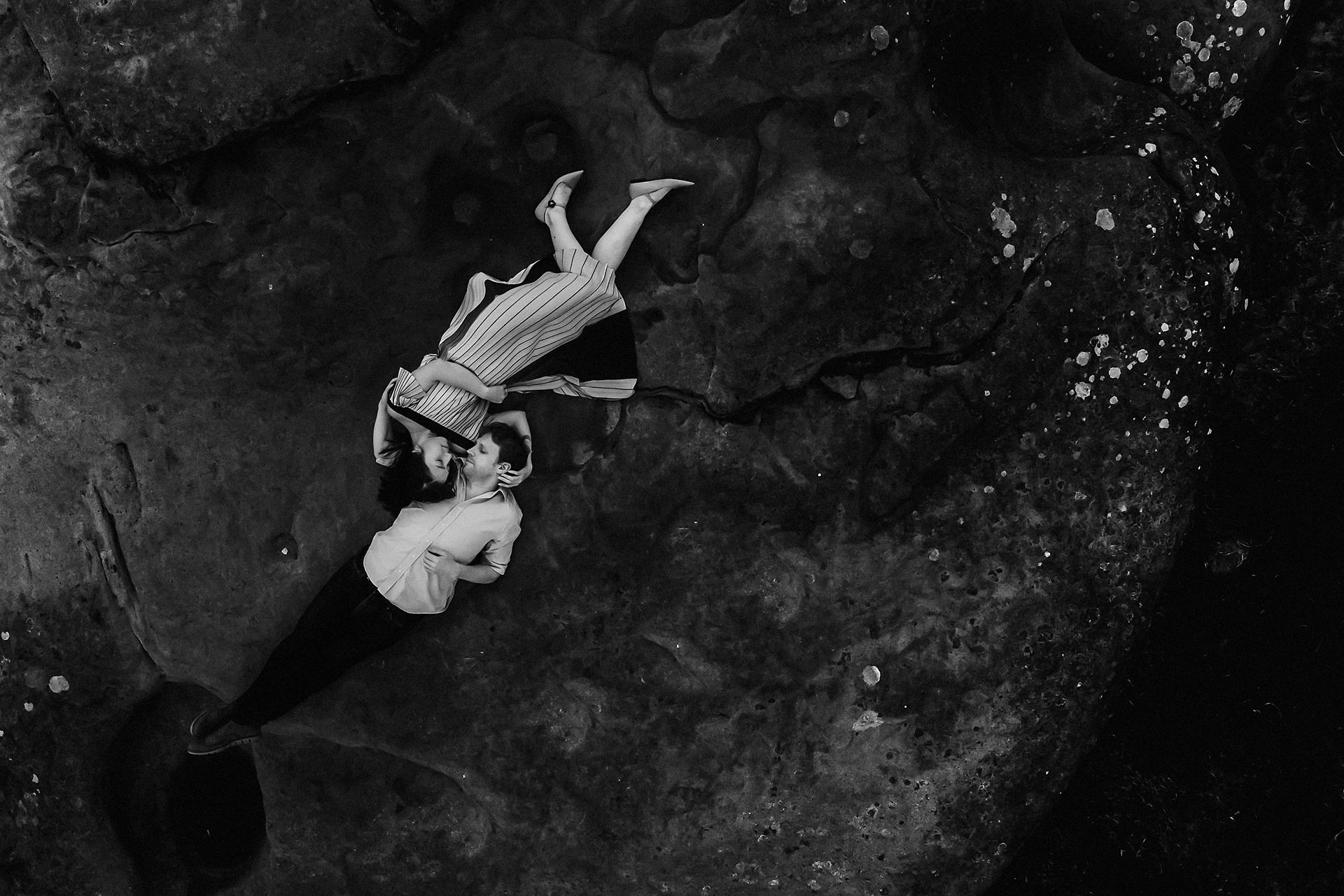 aerial photo of couple on rocks 