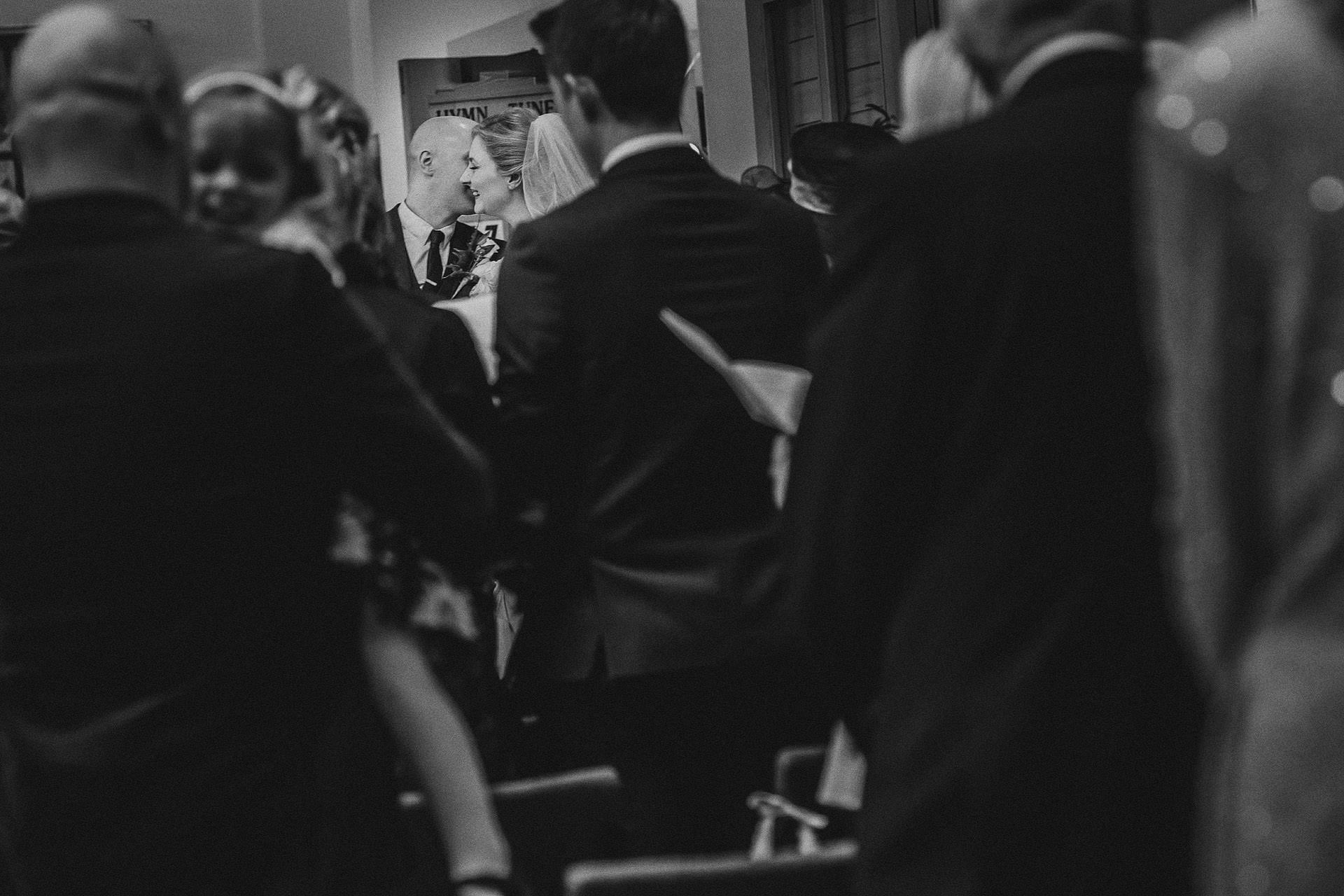 moment between the bride and groom in church 
