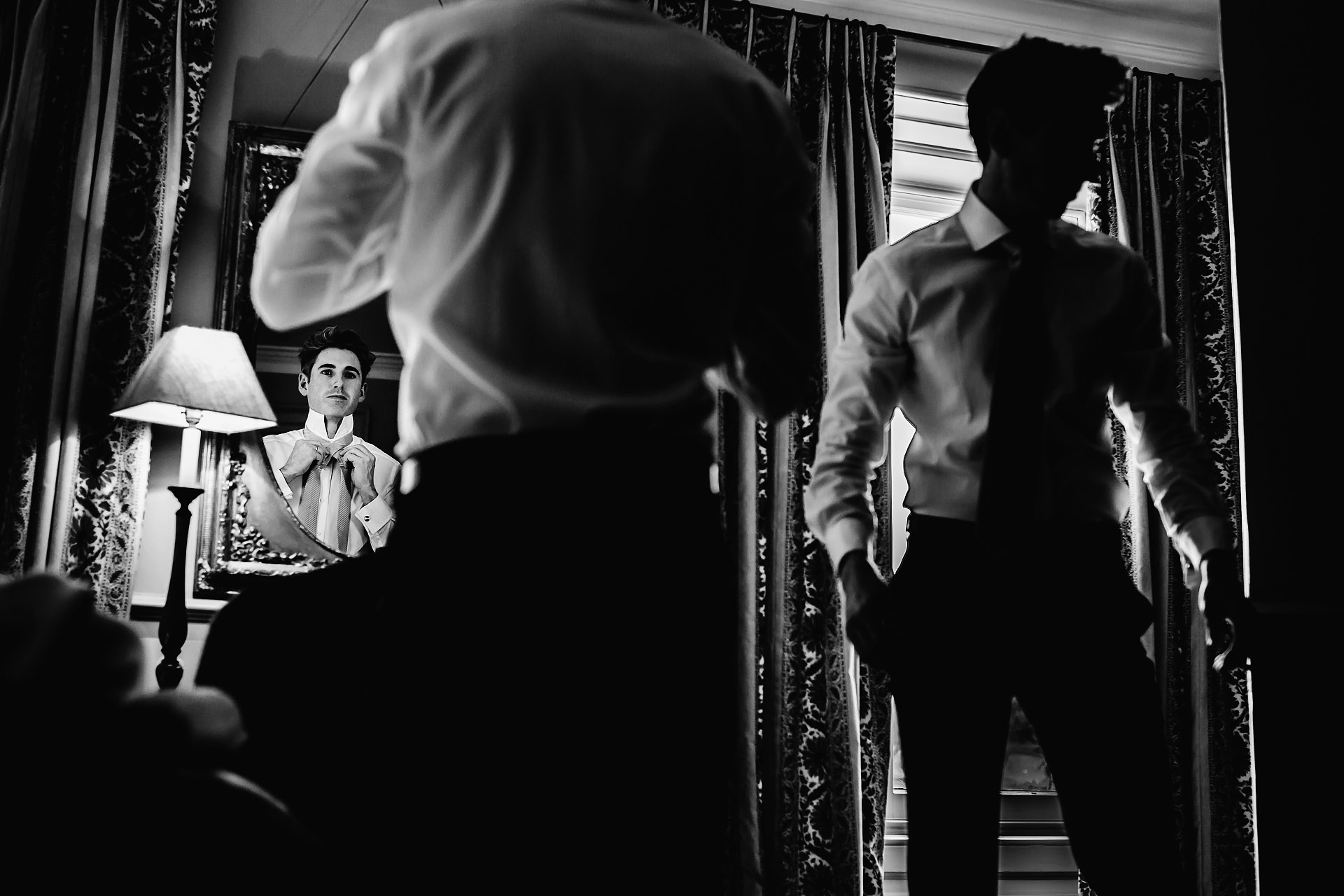 groom and best man getting read at the venue. Photograph by Boconnoc House Wedding Photographer Steven Rooney 