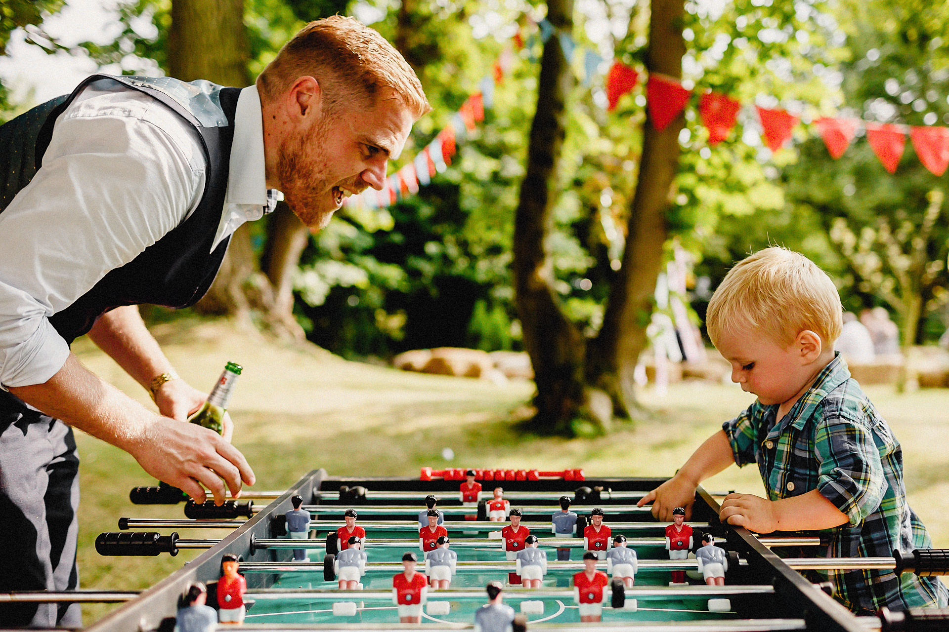father and son playing table football 