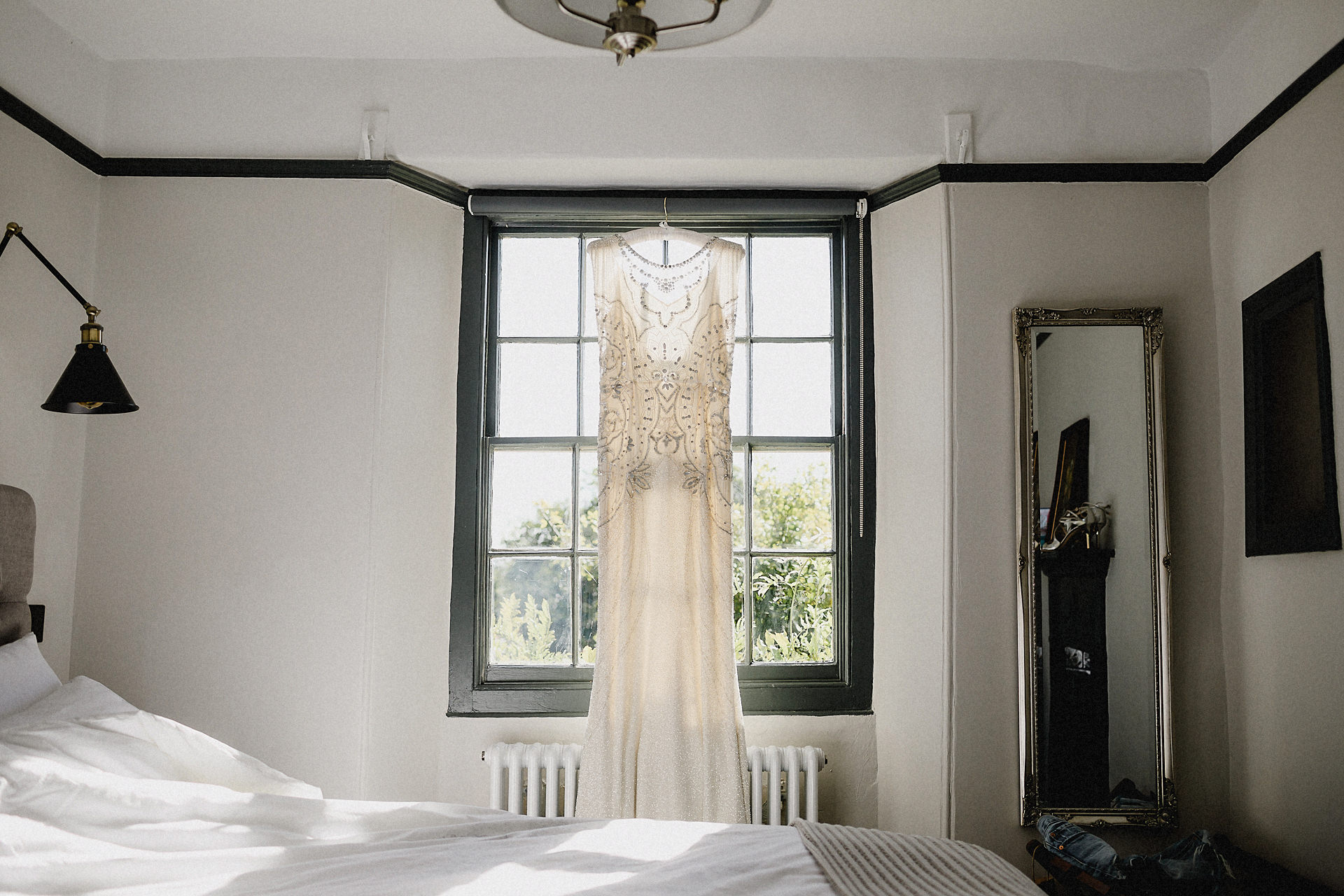 jenny packham dress hung up in the cottage