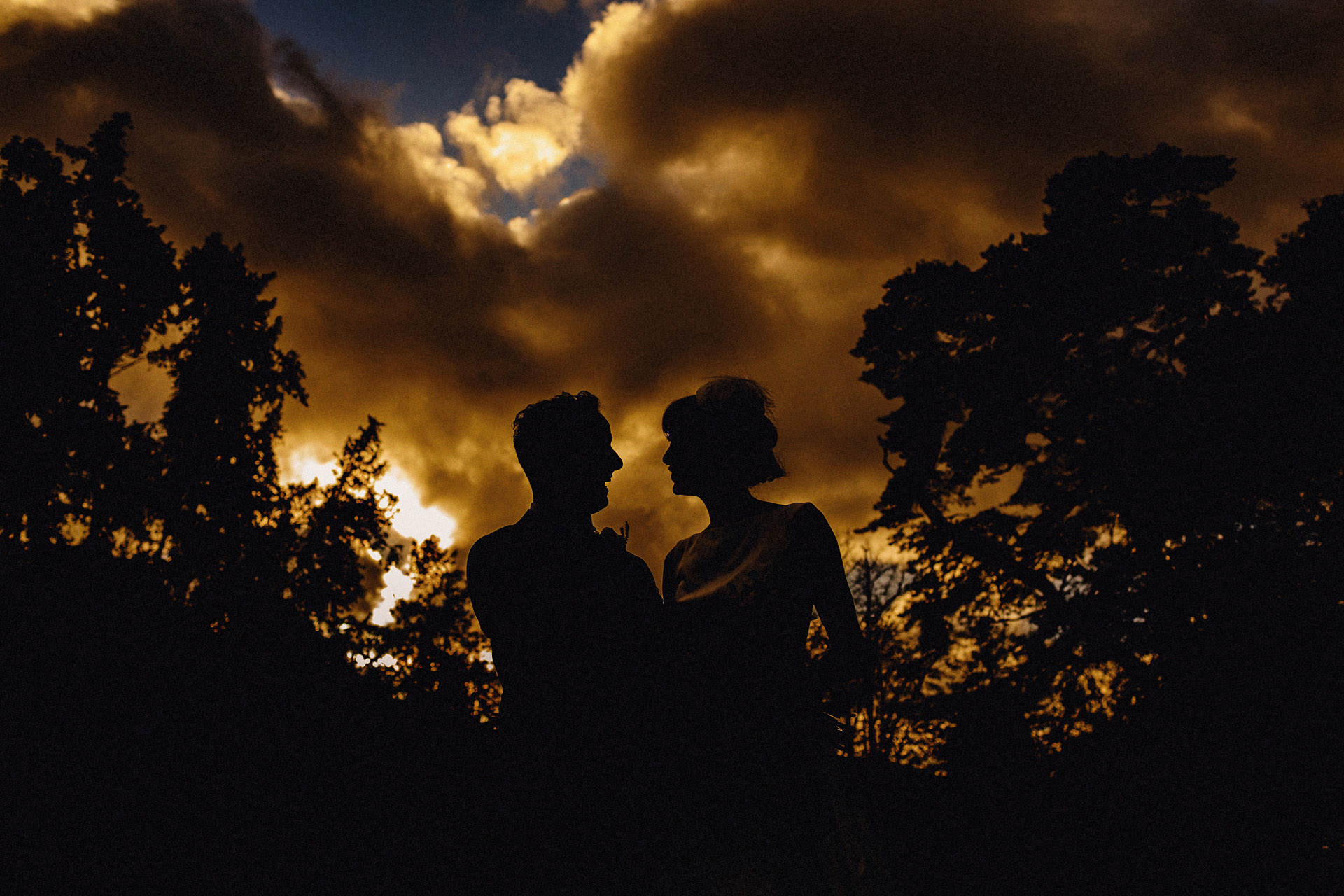 silhouette of the bride and groom outside the church 