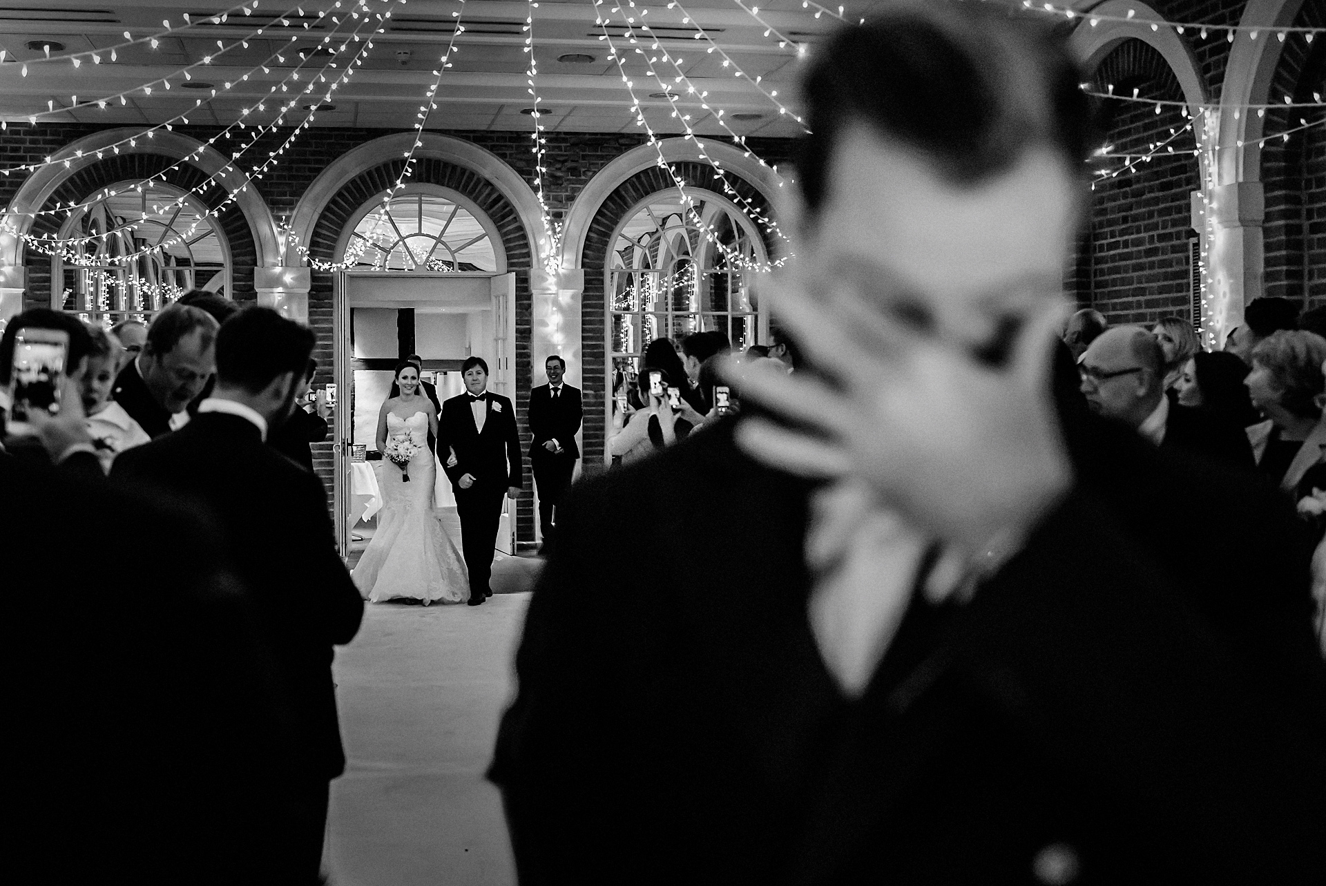 photo of the groom's reaction as the bride walks down the aisle