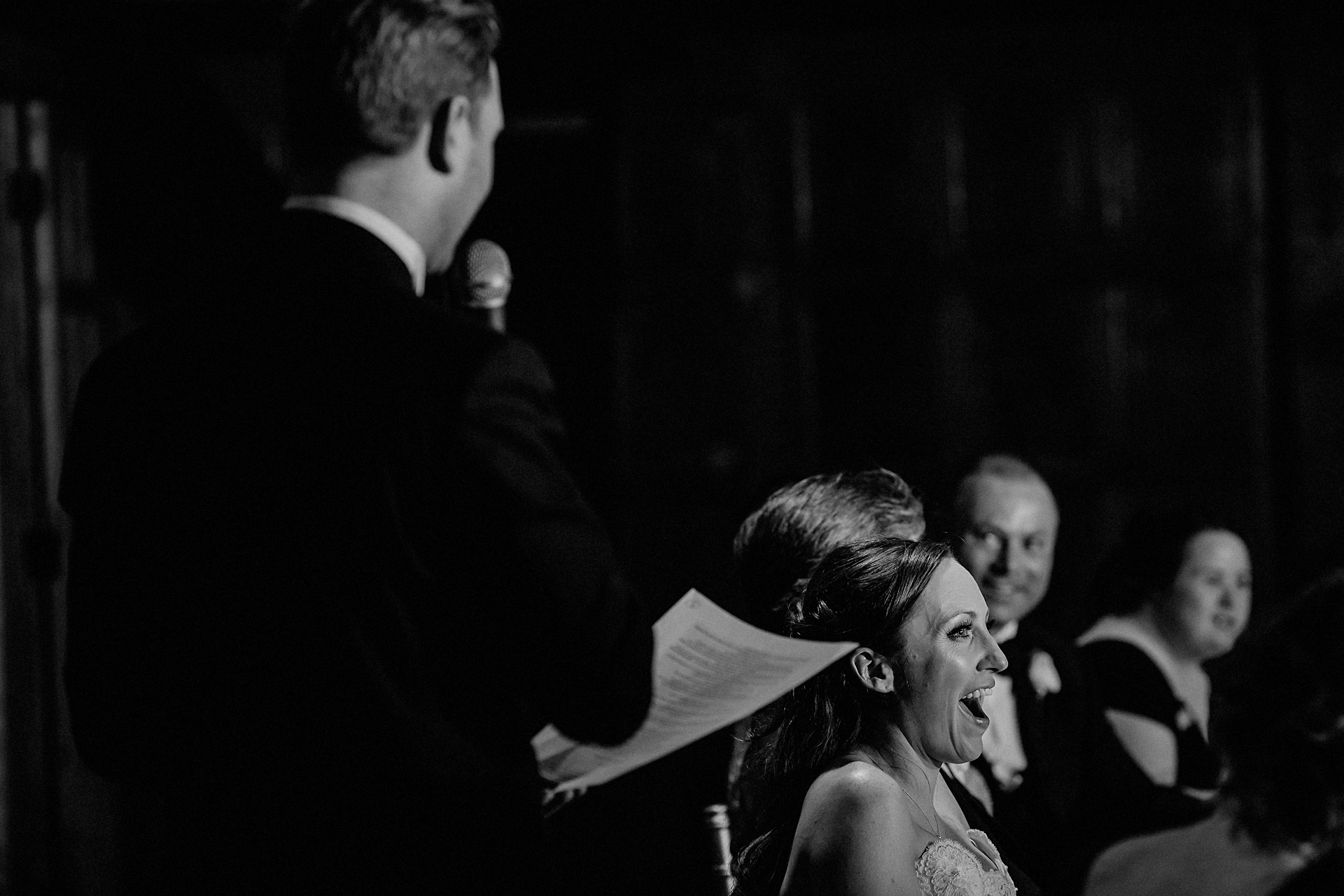 bride laughing at the grooms speech 