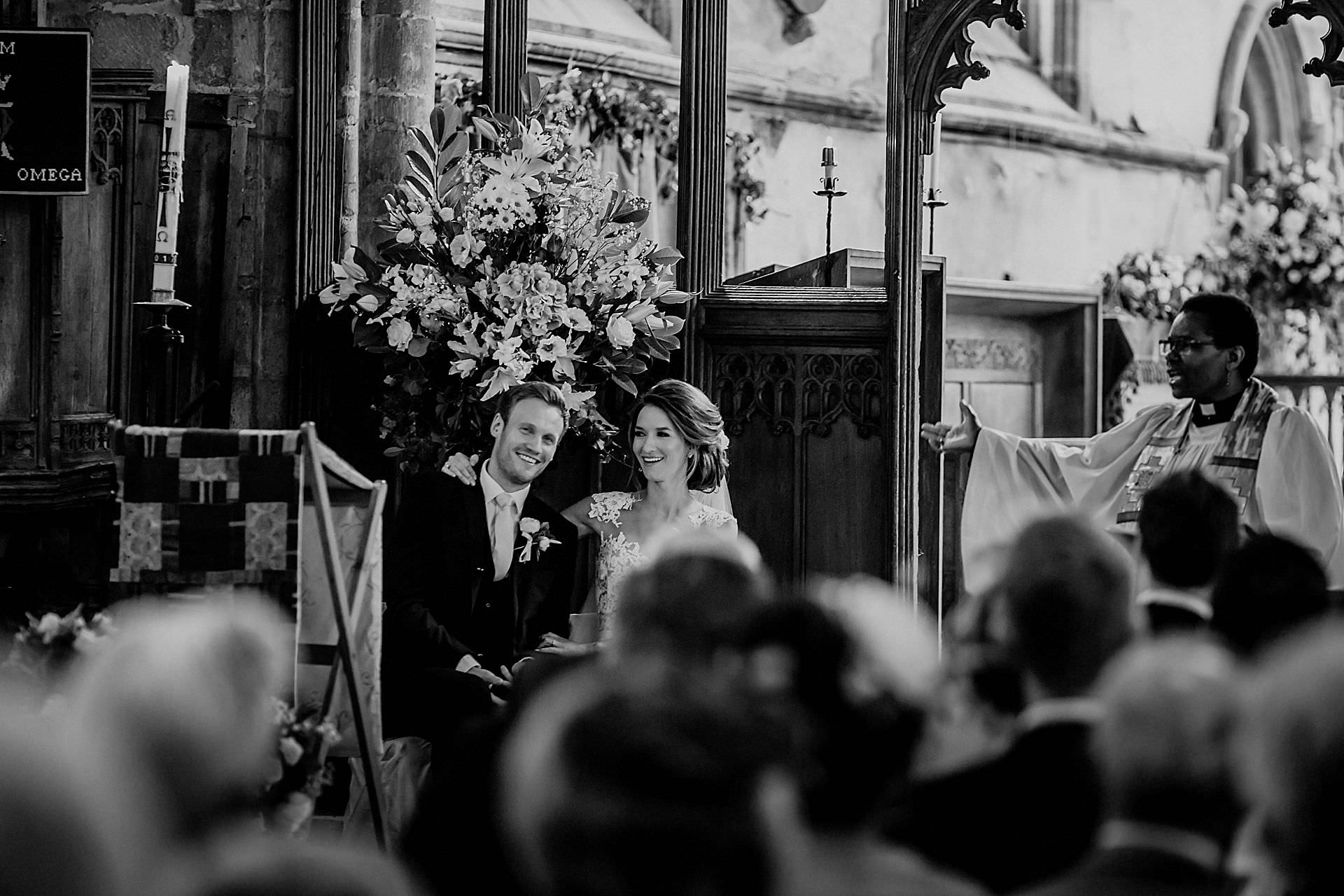 black and white photo of the couple in the church 