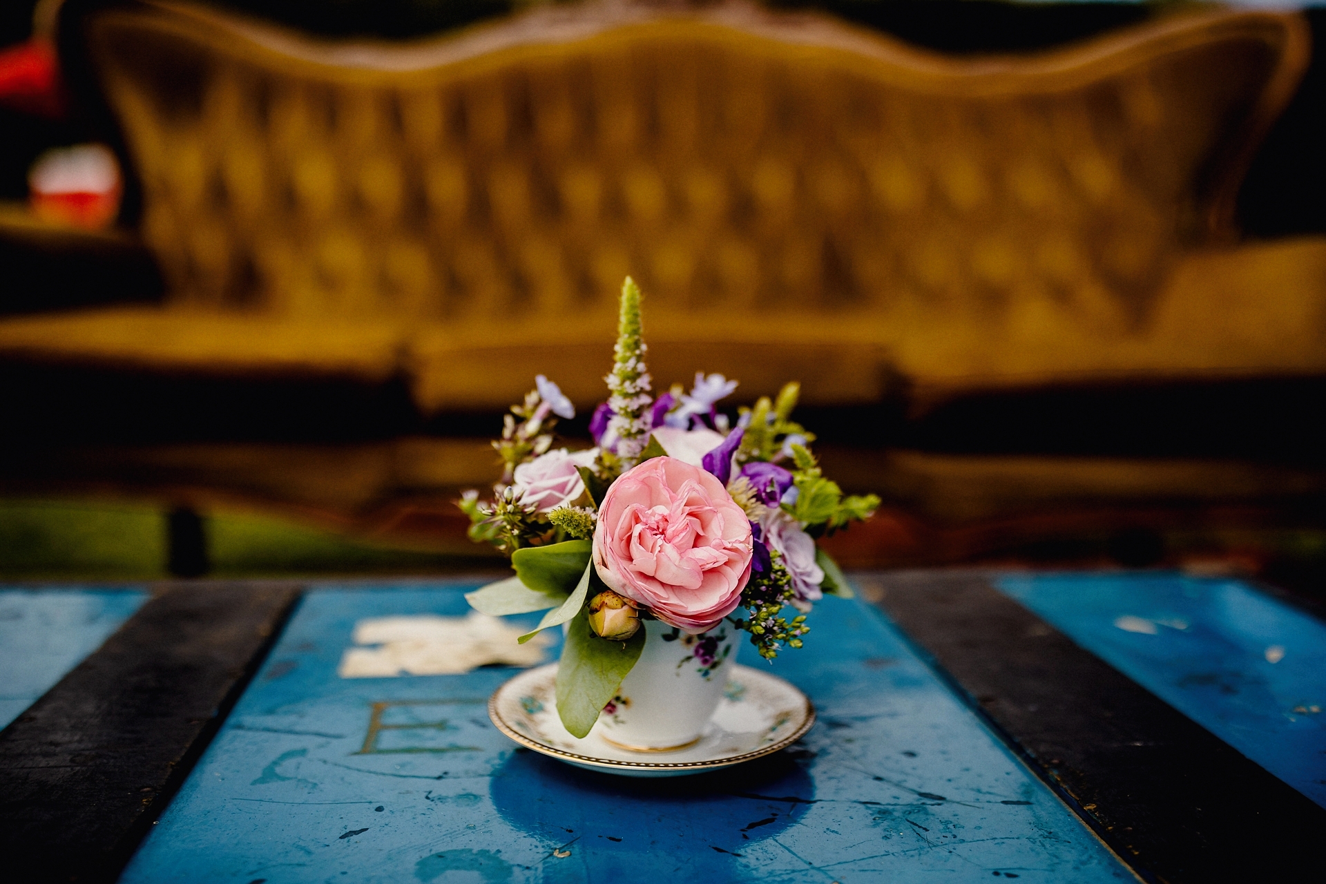 details from the vineyard wedding in kent, flowers in tea cup on table, vintage couch
