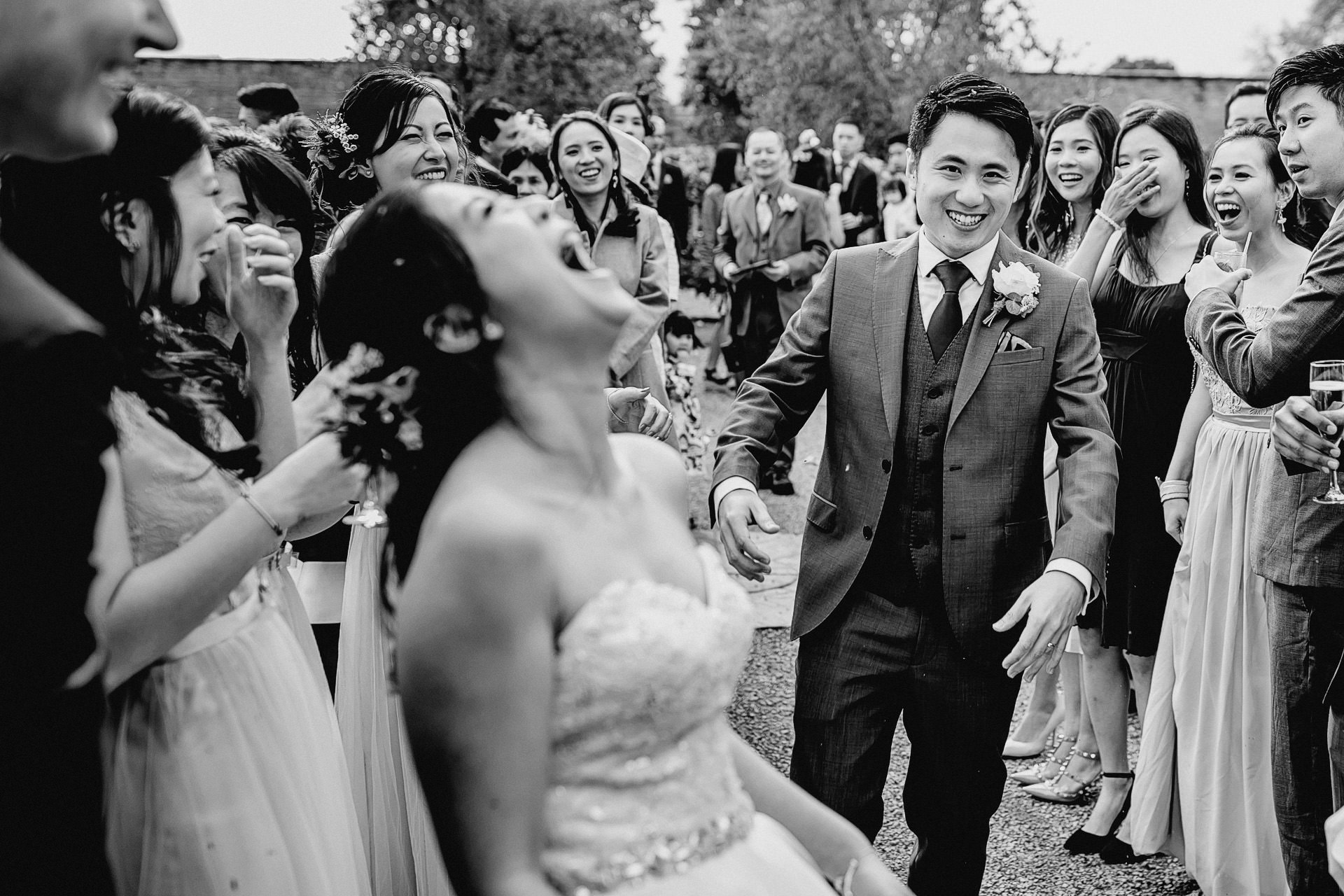 black and white photo of the bride laughing 