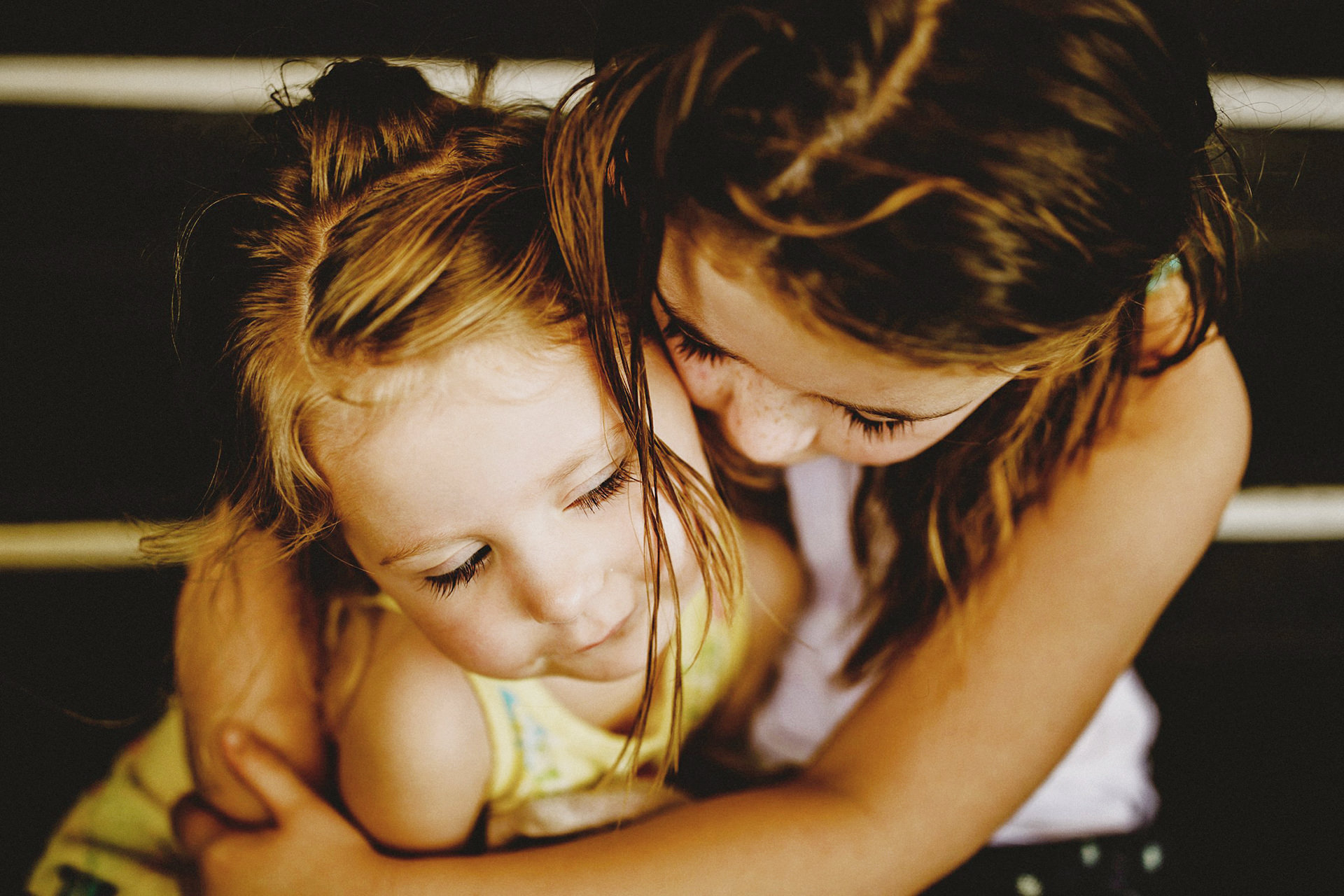 cuddling sisters