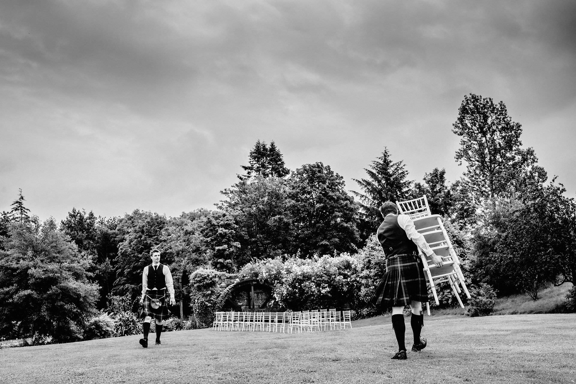 carrying chairs for the humanist ceremony in the garden