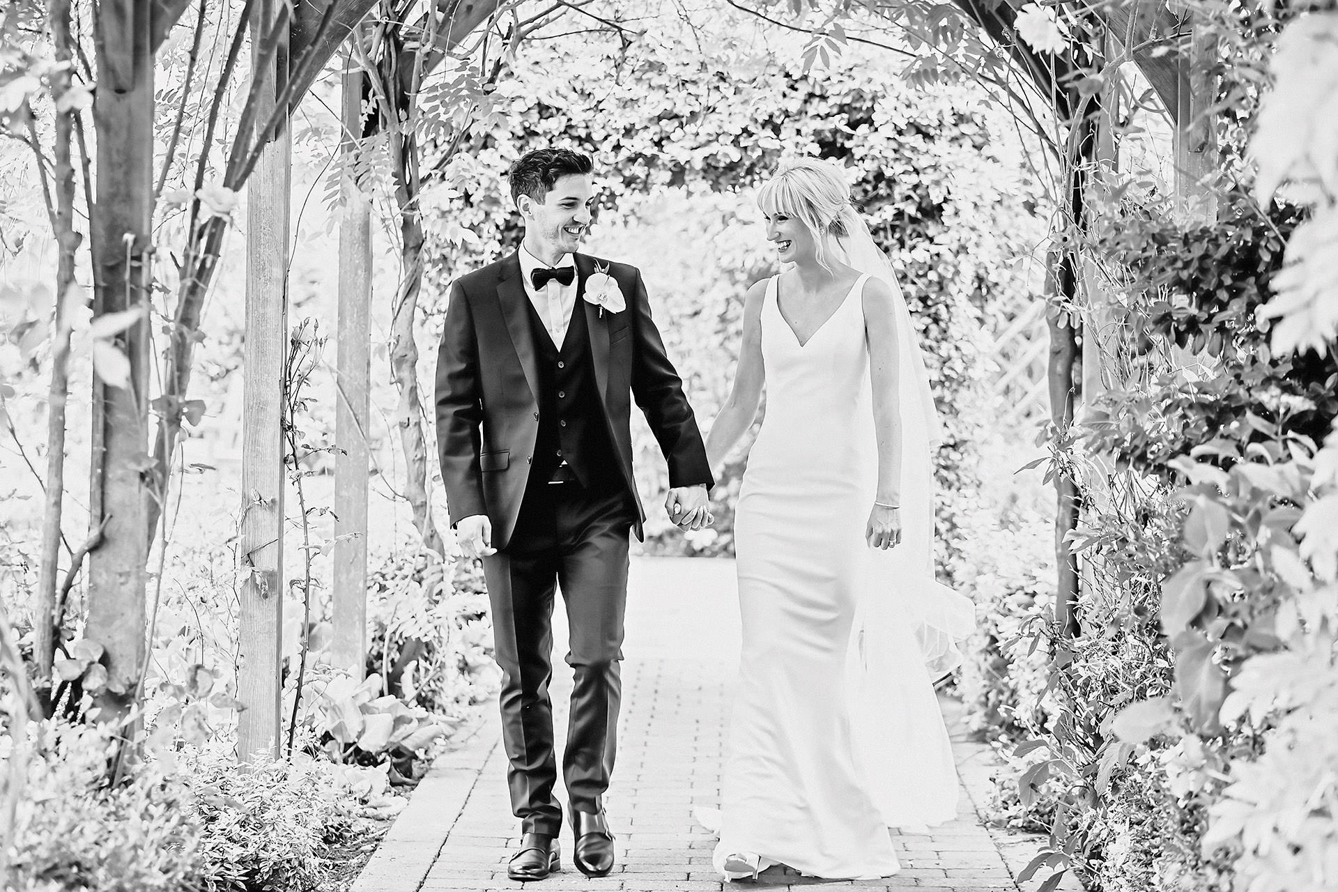 bride and groom walking, black and white photo
