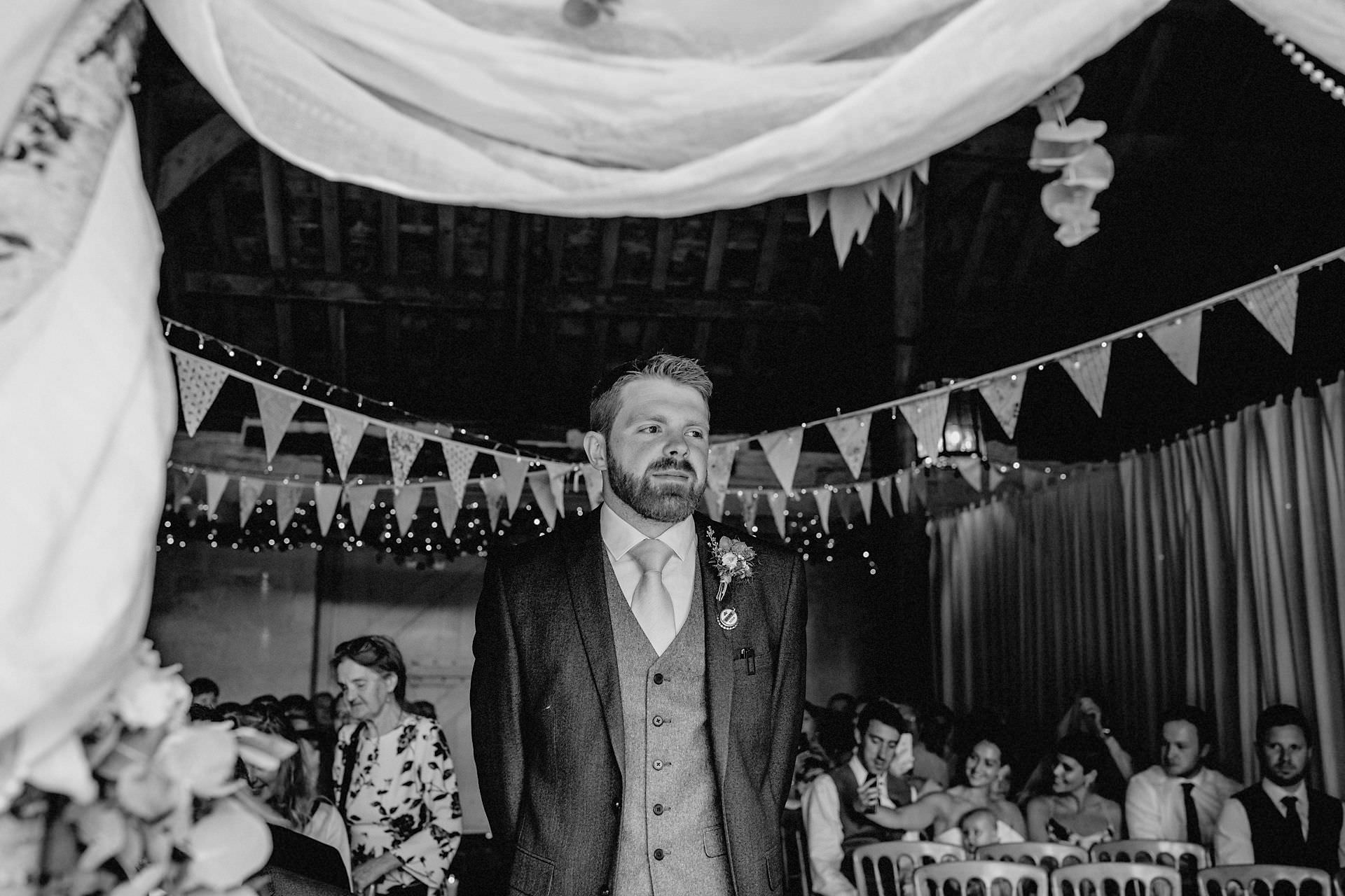 the groom waiting in the barn