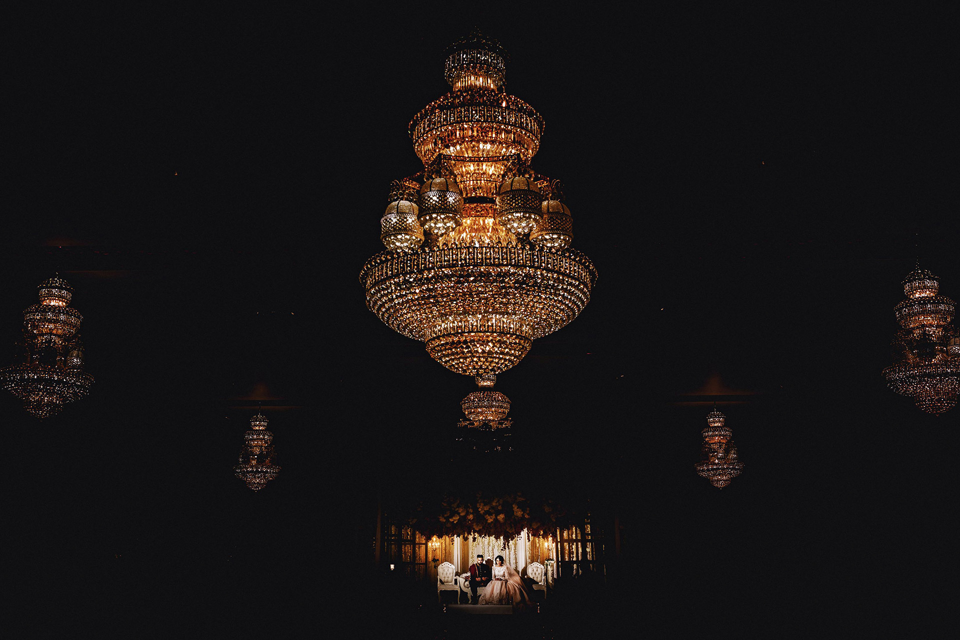 chandelier, bride and groom praying